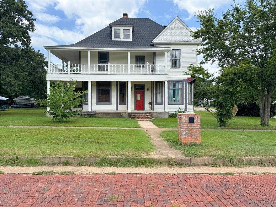 What a Beauty!
This timeless 5-bedroom, 2-bathroom treasure is brimming with historic charm and beautiful details from a bygone era. You will be drawn to the towering ceilings, authentic hardwoods steeped in history, and the majestic entryway with winding stairs leading up to a 2nd floor. Elegant wooden pocket doors slide open to reveal what was likely the parlor—perfect for cozy gatherings or quiet reflection.  Step outside onto a grand balcony or the wraparound porch, where you can savor the morning breeze or the peaceful night air. Nestled on a lofty corner lot, this home is surrounded by stately, towering trees that create a serene and picturesque setting. Recent updates include a brand-new roof and an almost-finished fresh coat of exterior paint, ensuring this classic beauty is ready to shine for years to come!