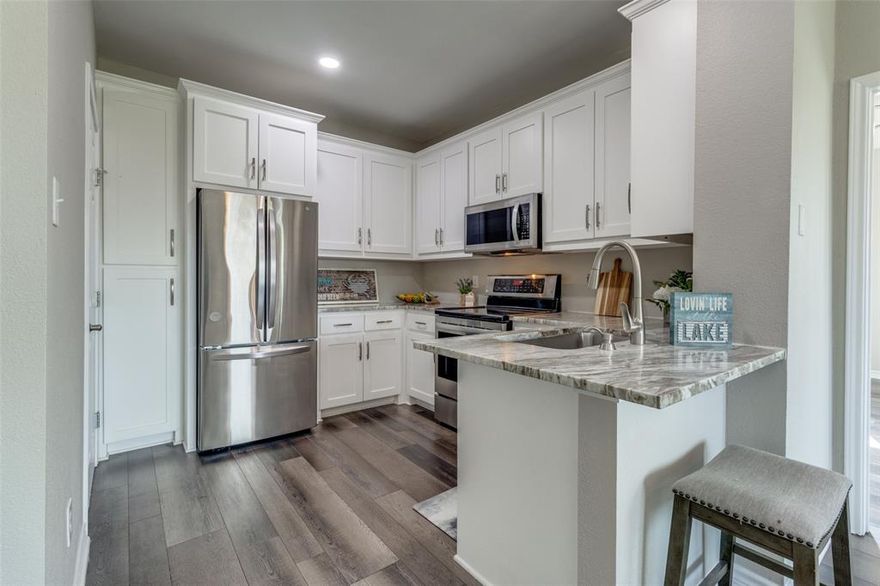 Experience refined living in this updated condo with a view of Lake Texoma from the balcony. Enjoy the modern allure of all new cabinetry, granite countertops, and state-of-the-art appliances. Ideal for both Airbnb hosting or a home away from home on the lake, this residence features two bedrooms and two full bathrooms, each accompanied by spacious walk-in closets. Nestled within a community offering a central pool and the convenience of an elevator. This condo also benefits from its proximity to the esteemed Tanglewood Resort with dining options, and the renowned Tower Whiskey Bar. With Lake Texoma and Highport Marina just a short stroll away, outdoor adventures are at your fingertips. Preston Harbor and the new Margaritaville Resort will be a 15-minute drive. Waterr heater was replaced in 2023. Additionally, exterior and roofing maintenance are provided by the HOA, guaranteeing a hassle-free lifestyle. Live the resort life every day in this exceptional condo offering the best of lakeside living.