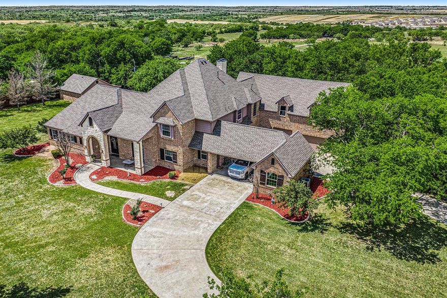 Welcome to your country living near the city!  Don't miss this amazing 19.7 acres with everything you need!  Gated entry, 2 bedrooms on main level including master, 2 bedroom upstairs complete with loft space.  Open kitchen to living,  gas cook top, 2 dishwashers, island, tons of cabinet space. Living area lights up with natural light, fireplace.   Oversize master with sitting area, fireplace, large walk-in closet with built-ins with access to pool. Upstairs living area includes open space, wet bar with mini fridge and a indoor half basketball court!  Abundance of storage! Walk out of your new home into your backyard oasis, pool with water feature, fenced, fire place and outdoor kitchen! 24 zone sprinkler system, 18.5 acres is ag exempt, fully stocked tank with bass and catfish.  Multiple garage space to hold 6 cars.  Great location, 10 minutes from shopping, about 12 miles to downtown and about 20 to 30 minutes to DFW airport.