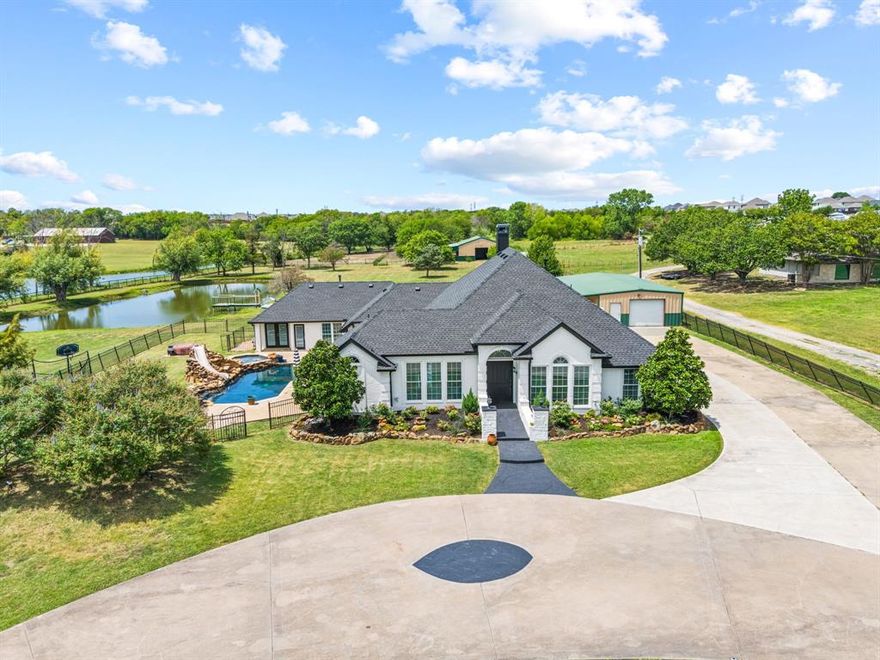 This sprawling 5-acre estate offers the perfect blend of luxury, functionality and outdoor living. Boasting 3,301 sq ft of beautifully updated space, this 5-bedroom, 3-bath home is ideal for multigenerational living, entertaining, or simply spreading out and enjoying the peace and privacy of country life—all within the rapidly growing community of Royse City. Step inside to discover modern finishes, accent walls, upgraded lighting and neutral flooring throughout. The open-concept layout features a flexible space up front perfect for a home office or formal dining, a spacious game room, and a cozy living area complete with custom built-ins and a gas fireplace. The kitchen is a chef’s dream with quartz countertops, a built-in commercial refrigerator, gas cooktop and breakfast nook—all bathed in natural light thanks to glass sliding doors that open seamlessly to the back patio. The primary suite offers a luxurious retreat with double vanities, an oversized shower, separate soaking tub and walk-in closet. Three additional bedrooms share a full bath with dual sinks, while the fifth bedroom is ideal for a guest suite or mother-in-law quarters, complete with its own full bath, bonus room (with space to add a kitchenette) and private patio access. Outside amenities and features are seemingly endless; the property is fully fenced with a gated entrance and circle driveway, offering ample concrete parking, garage space and room for an RV or boat! Plus a 53x22 powered workshop with a lean-to, horse barn with stables, a greenhouse, raised garden beds and even a serene fishing pond—topped off with a sparkling pool featuring a spa and slide for endless outdoor enjoyment. Freshly painted brick exterior and sleek, modern updates make this home move-in ready. Whether you're seeking a hobby farm, space to grow, or your own family retreat—this one-of-a-kind property delivers. Don’t miss this rare opportunity to own a true Texas gem!
