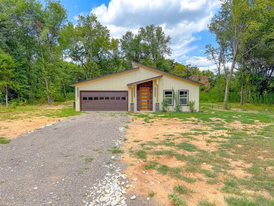 Modern design meets quiet country living on over half an acre in Freestone county. This 2025 new construction is privately tucked away just off FM 27 in Fairfield, surrounded by mature trees and set on a spacious, wooded lot that offers both privacy and room to breathe. With easy access into the town but a setting that feels worlds away, this home is ideal for anyone looking for that rare blend of modern comfort and rural charm. Inside, you'll find a bright and open floor plan with high ceilings and clean lines that create a sense of space from the moment you walk in. The kitchen is anchored by a large center island and finished with granite countertops, custom cabinetry, and seamless flow into the dining and living areas- Ideal for everyday living or entertaining. This is a home for someone who appreciates design, but values privacy even more. For someone who wants their home to feel like a retreat, Not just a place to sleep. If that's you, this property isn't just a house. It's your next chapter, Waiting.