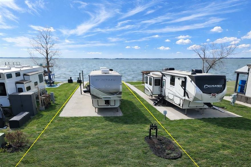 Wake up to lake breezes and wind down with unforgettable sunsets at this waterfront RV lot in the luxury, gated RV community of Peninsula Point on Richland Chambers Lake—perfectly positioned halfway between Dallas and Houston for easy weekend escapes or extended stays. Lot 98 is truly turnkey, with a concrete RV pad already poured, a steel retaining wall topped with an extra wide concrete sidewalk and water stairs in place. A sturdy shade sail setup is already installed so you can start enjoying the view from day in comfort and as an additional bonus feature the Seller has installed a lake pump and sprinklers to ensure that your piece of paradise stays enjoyable year round with a lush green lawn! Sunset skies reflect across the water nightly, creating the ideal backdrop for relaxed evenings by the lake from this prime location out on the end of the peninsula... it just doesn't get any better than this. 

Peninsula Point offers resort-style amenities with peace of mind, including monitored access via a park ranger, an outdoor clubhouse with grill station and laundry facilities, a swimming pool, boat ramp, boat storage when available, a fishing pier, playground, fenced dog potty area, and paved roads throughout the community. Utilities are already installed at each site for sewer, water, and electric, making setup simple and stress-free and as a money saving bonus, the Tap Fee has already been paid on this lot!

Whether you’re chasing sunsets, spending long days on the water, or enjoying quiet mornings by the shore, this waterfront RV lot delivers an effortless lake lifestyle in one of Richland Chambers Lake’s most sought-after RV communities. RV, Patio furniture and Kayak are not included in the listing.