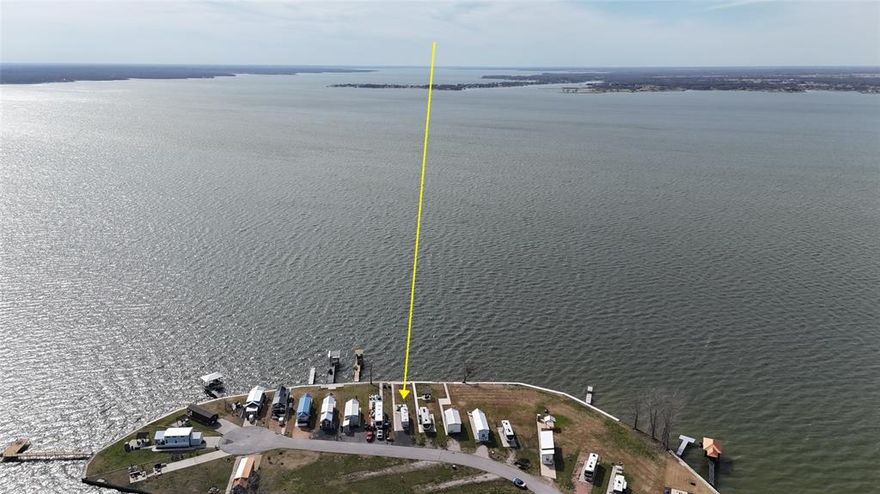 Wake up to lake breezes and wind down with unforgettable sunsets at this waterfront RV lot in the luxury, gated RV community of Peninsula Point on Richland Chambers Lake—perfectly positioned halfway between Dallas and Houston for easy weekend escapes or extended stays. Lot 98 is truly turnkey, with a concrete RV pad already poured, a steel retaining wall topped with an extra wide concrete sidewalk and water stairs in place. A sturdy shade sail setup is already installed so you can start enjoying the view from day in comfort and as an additional bonus feature the Seller has installed a lake pump and sprinklers to ensure that your piece of paradise stays enjoyable year round with a lush green lawn! Sunset skies reflect across the water nightly, creating the ideal backdrop for relaxed evenings by the lake from this prime location out on the end of the peninsula... it just doesn't get any better than this. 

Peninsula Point offers resort-style amenities with peace of mind, including monitored access via a park ranger, an outdoor clubhouse with grill station and laundry facilities, a swimming pool, boat ramp, boat storage when available, a fishing pier, playground, fenced dog potty area, and paved roads throughout the community. Utilities are already installed at each site for sewer, water, and electric, making setup simple and stress-free and as a money saving bonus, the Tap Fee has already been paid on this lot!

Whether you’re chasing sunsets, spending long days on the water, or enjoying quiet mornings by the shore, this waterfront RV lot delivers an effortless lake lifestyle in one of Richland Chambers Lake’s most sought-after RV communities. RV, Patio furniture and Kayak are not included in the listing.