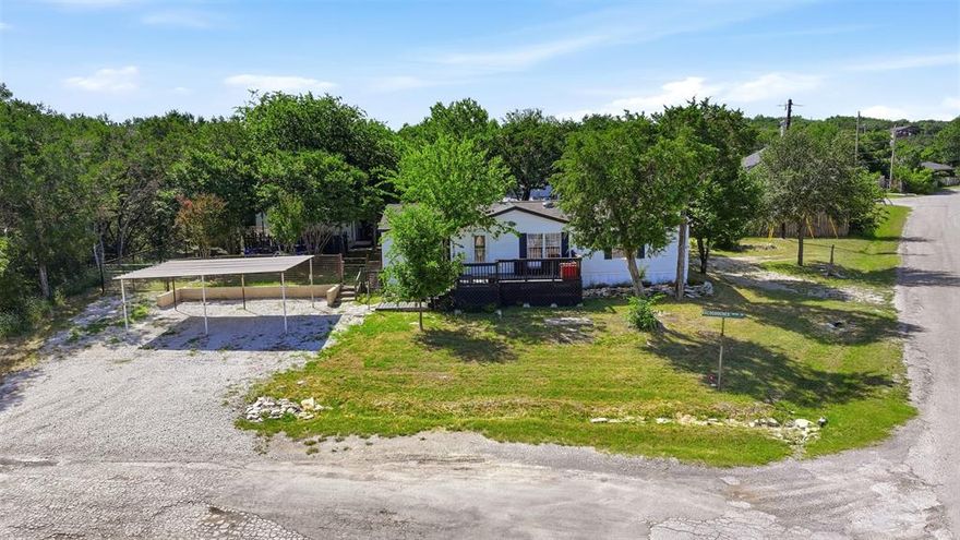 Well-maintained 3-bedroom, 2-bath mobile home in the desirable Comanche Cove community near Lake Granbury. Offering 1,344 square feet of comfortable living space, this property is located just one block from the lake and provides access to community common areas, mature trees, and a peaceful neighborhood setting.

The home features a spacious layout with comfortable living and dining areas, a functional kitchen, and a private primary suite. Covered carport parking adds convenience, while the low annual HOA fee of only $105 makes this an affordable opportunity for full-time living, a weekend retreat, or investment property.

Enjoy the relaxed lake lifestyle while being just minutes from shopping, dining, and historic downtown Granbury.