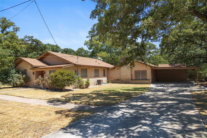 Spacious classic home! 1950s built 5-bedroom brick with 3 full baths, one having a Jacuzzi tub! 3511 sq. ft. of living area, huge den with an exposed beam cathedral ceiling and a brick woodburning fireplace with a full width hearth.  Large walk-through island kitchen with ample cabinets and built-in appliances, built-ins include the range-oven in the island, a second built in oven, dishwasher and a disposal.  Home includes a large game room or office with a closet.  Two central air-heat zones with Natural gas furnaces, 2 Natural gas water heaters, a HUGE 12x16 (approx) Cedar lined closet, a 6 year old composition roof and an attached 2 car carport.  Out back there is a covered patio overlooking the back yard which has a storage building with a lean-to shed, a water well and well house, several beautiful old Post Oak trees and the yard area is all under an automatic underground yard sprinkler system.  Grand old house! Call us to schedule an appointment to see it!!