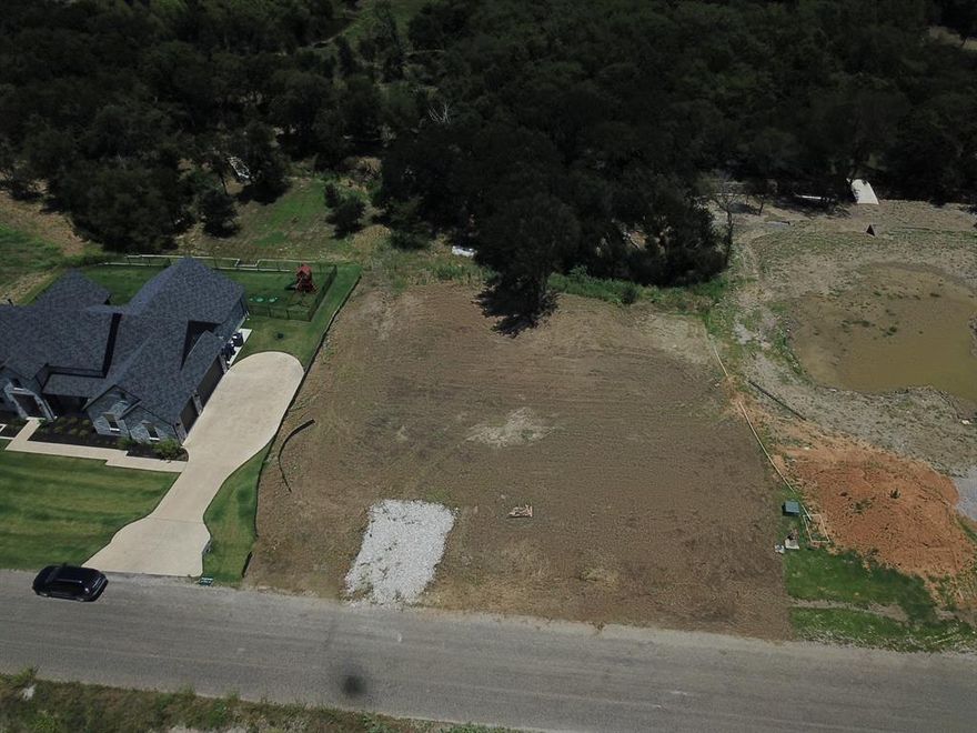 Build your dream home in the heart of Gunter’s newest subdivision! This 2-acre gem is a perfect mix of open space and natural beauty—with a level homesite ready for your custom design. A seasonal creek runs through the property, creating a peaceful setting with awesome views and a wooded area to explore, unwind, or even carve out your own backyard trail. Whether you're into modern farmhouse vibes or sleek architectural style, this property gives you the space and setting to create something special. Tucked in a fast-growing community with a rural feel and easy access to the city—this is where country charm meets a modern lifestyle. Come walk the land and imagine the possibilities!