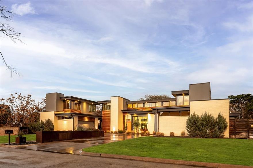 Located in the heart of Dallas, 9360 Lakemont Drive stands as the final masterpiece of renowned modern architect Tom Greico. Spanning 4,981 square feet, this residence masterfully blends industrial chic with functional luxury—from the visible texture of polished concrete floors to the invisible comfort of a seven-zone Russound audio  system and comprehensive Culligan whole-house water filtration.
The home's centerpiece is a sprawling chef’s kitchen, designed for connection. It features a unique serving window to the backyard and flows effortlessly into an open dining area and family room anchored by soaring, two-story ceilings. On beautiful Texas days, retractable sliding glass doors disappear to reveal a private, resort-style oasis. This outdoor sanctuary boasts an ozone purification pool, a sunken fire pit, and an outdoor kitchen with a built-in grill, all framed by multiple green spaces and a custom- built playhouse that architecturally mirrors the main
residence. The primary suite serves as a true sanctuary, offering serene outdoor views, a spa-inspired bath with a soaking
tub and separate shower, and an expansive walk-in closet featuring an oversized center island. Every detail of this home is elevated by modern convenience, including remote-controlled shades and high-end utility systems. Perfectly positioned near top-tier private schools and
walkable local favorites, this property represents a rare opportunity to own a significant piece of Dallas architectural history.