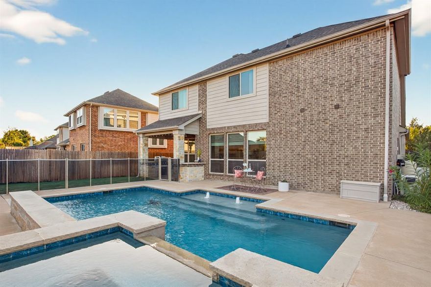 Find your sanctuary in the vibrant Country Lakes community with this beautifully designed two-story home by Bloomfield Homes, offering 4 spacious bedrooms, 2.5 bathrooms, and multiple living and dining areas across over 3,000 sq ft of thoughtfully crafted space. Neutral tones, wood-look tile floors & soaring ceilings with recessed & decorative lighting welcome you home, while expansive windows illuminate the open-concept layout, ideal for everyday living & seamless entertaining. A secluded office with French doors lends itself as the perfect office retreat, playful flex space, or formal dining. Impressive and inviting kitchen features granite countertops, an abundance of white cabinetry, decorative tile backsplash, stainless steel appliances, & a generously sized 10' × 9' walk-in pantry. Kitchen with a dining space that opens seamlessly to the main living with beautiful fireplace adding warmth and a wall of windows overlooking the backyard true retreat complete with a covered patio with built-in grill, fridge, prep space, gorgeous modern heated saltwater pool, spa, & peaceful water feature for resort-style relaxation for all seasons. Spacious primary suite showcases a spa-inspired bath with a garden tub, separate shower, dual quartz vanities, tiled floors, & a large walk-in closet with built-ins. Upstairs, you will find a game room with walk-in closet leading to attic storage that offers space to store & organize. Three additional bedrooms with large windows & closets, two overlook the backyard. A tucked-away media room with decorative lighting flexes as a gym, featuring removable rubber flooring. Additional features include a Generac standby generator & a removable safety fence that can separate the pool from the home & yard. Incredible community amenities, top-rated schools & convenient commuter routes, this home is more than a house, it’s a lifestyle! Enjoy a 640-acre community with trails, lakes, pools, playgrounds, dog park, soccer field, outdoor fun and more!