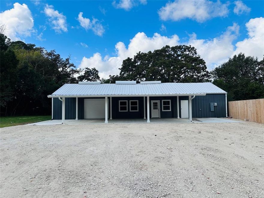 Enjoy the perfect blend of country charm and modern comfort with this 1,750 sf, 3 bedroom, 2 bath barndominium on 5.59 wooded acres. The open-concept floor plan features vaulted ceilings, rich wood cabinetry, stainless steel appliances, and durable vinyl plank flooring throughout. A large gravel driveway and parking area provide plenty of space for vehicles, trailers, or guests. The attached garage with roll-up door offers flexible use with an upstairs attic area providing ample room for storage or potential future expansion. With no restrictions, you can truly make this property your own by adding additional homes, a mobile home, or a tiny house. Bring your ideas and make this versatile property your own!