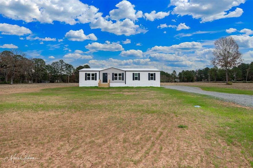 This brand new 3-bedroom, 2-bath home sits on a spacious ½-acre lot in a quiet neighborhood in the Haughton School District. Featuring modern finishes throughout and custom-style built-ins in the living room, this home offers both function and charm. Included in the sale are a covered back porch, front  and side door steps, gravel driveway, and skirting — all complete and ready for move-in. Located just steps away from the neighborhood fishing pond, this property offers affordable living with a small-town feel and plenty of space to enjoy life outdoors. Stylish. Comfortable. Move-in ready. An excellent option for those wanting affordable housing without sacrificing quality or character.