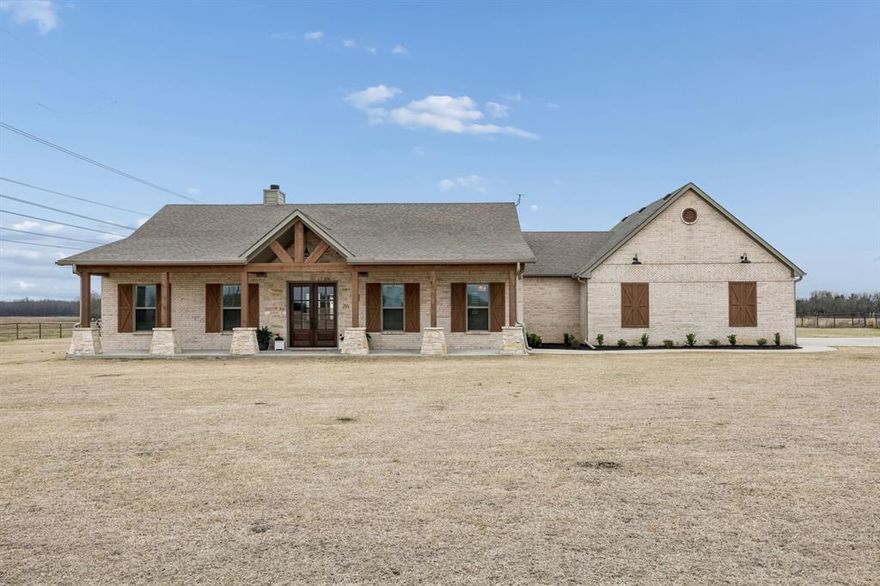 Situated on nearly two acres in a peaceful country setting within Community ISD, this exceptional four-bedroom, three-bath home offers space, privacy, and freedom — with no HOA, MUD, PID or city taxes. A long private driveway provides abundant parking and leads to a massive oversized 27x35 two-car garage. The inviting front porch welcomes you into a spacious and impressive entryway, highlighted by stunning custom double doors that create a memorable first impression. Inside, vaulted ceilings and a beautiful stone wood-burning fireplace with gas start anchor the expansive living room. A dedicated study offers the perfect work-from-home space, while a secondary bedroom is currently being used as a gym, showcasing the home’s flexibility. The kitchen is designed to impress, featuring a large island, shaker-style cabinetry, abundant counter space, and an incredible walk-in pantry many will envy. The oversized utility room offers extensive cabinetry, countertops, and storage, plus a convenient folding area located just off the primary closet for everyday ease. This open plan allows for the most perfect sized table for your eating experience or pull up a chair to your ideal island. The private primary suite is a true retreat, complete with a luxurious ensuite bath offering dual vanities, generous storage, and a custom walk-in shower with dual rainfall showerheads. Step outside to an oversized covered back patio ideal for entertaining, grilling, or simply relaxing while enjoying peaceful country views. You will see many special touches were applied in this dearly loved custom home, but don't miss the tankless water heater, well-appointed irrigation, the amazing garage storage closet, special safe, custom primary closet details, and more. With nearly two acres to call your own, this property delivers the perfect balance of comfort, function, and laid-back country living.