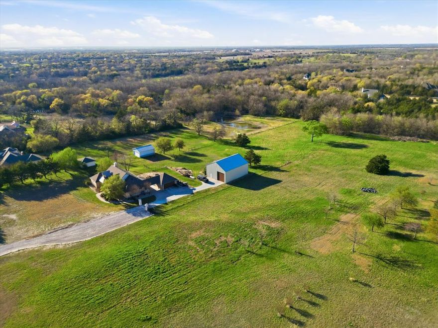 Welcome to 4505 County Road 408 in northwest McKinney, where peaceful country living meets convenient access to the city. Situated on 3.5+ beautiful acres, this stunning property offers privacy, space, and versatility with a large 2,000 sqft 40'x50' with 14'x14' garage door workshop - perfect for hobbies, business use, equipment storage, or recreational vehicles.

The home showcases warm stone and wood finishes that create a timeless, inviting feel throughout. Inside, you’ll find spacious living areas designed for both everyday comfort and entertaining. Large windows bring in natural light and provide scenic views of the surrounding acreage.

Step outside to the back patio overlooking a lush, green backyard, ideal for relaxing evenings, outdoor dining, or simply enjoying the peaceful setting and wide-open spaces.

The expansive property provides plenty of room for outdoor activities, gardening, animals, or future additions, all while maintaining the privacy and tranquility of country living.

Despite the serene setting, the home offers convenient access to nearby destinations:
• ~10 minutes to Historic Downtown McKinney Square
• ~12 minutes to McKinney National Airport
• ~15 minutes to US Highway 75
• ~18 minutes to Sam Rayburn Tollway (SH-121)

This rare property offers the perfect balance of acreage, functionality, and proximity to McKinney’s dining, shopping, and commuting routes.