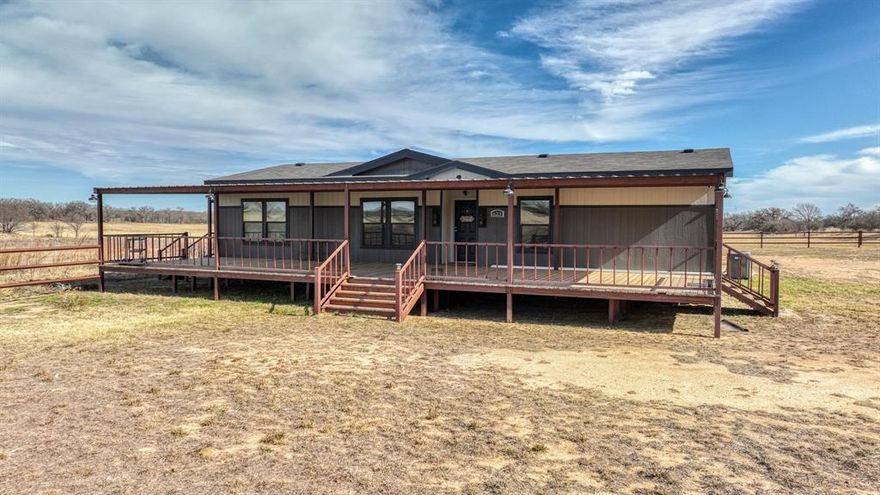 Quiet 20 acre property with county road frontage on two sides featuring a 2024 manufactured home offering 3 bedrooms, 2 bathrooms, and a dedicated media room. Enjoy outdoor living on the 57’ x 16’ covered deck, perfect for watching the sunset.
The property is serviced by a private water well and includes a 24’ x 57’ rear carport with ample covered parking. An 8’ x 4’ storage area located under the carport that is plumbed.Improvements include a 24’ x 75’ open-sided metal barn with a tack room, suitable for equipment, livestock, or future horse use. A 150’ x 250’ arena pad is already in place, making this property well suited for equestrian or agricultural use with room to customize.