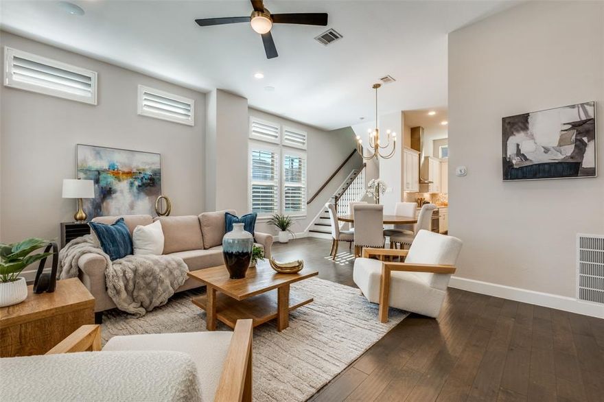 This multi-level townhome sits on a desirable corner lot and offers exceptional private outdoor space—including a fenced front yard, side yard, and a rooftop deck with panoramic views of downtown Dallas. Thoughtfully designed and well maintained, the home features wood floors throughout, 4-inch hidden tilt wood shutters and custom lighting. The kitchen is both functional and stylish, with quartz countertops, stainless steel appliances, and modern fixtures. An adjacent dining area, oversized living room with soaring ceilings, and a sleek powder bath make the second floor ideal for entertaining. The primary suite includes a spacious walk-in closet and a spa-like bathroom with dual vanities and a large shower. Two additional bedrooms each have private ensuite baths, offering comfort and privacy for family or guests. Conveniently located near Love Field, and Dallas’ top dining and entertainment districts!