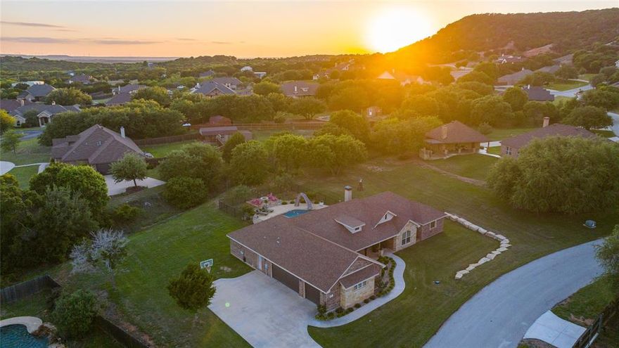 Step into your dream home nestled on almost an acre lot, outside the city limits, where stunning natural beauty meets effortless elegance with an outdoor oasis. This meticulously crafted 4-bedroom, 3-bathroom residence boasts an impressive 2,429 square feet of living space, perfectly tailored to accommodate your most discerning tastes. The spacious open living highlights the stunning stone fireplace filled with an abundance of natural light along with warm neutral colors and wood-like tile flooring. Fall in love with this masterfully designed chef's kitchen complete with knotty alder cabinets, stainless appliances, granite counters, statement lighting and a large walk-in pantry. The adjoined dining area, framed by charming barn doors flows seamlessly to a second living area or flex room offering functionality and elevated entertaining. The primary suite features recessed ceilings, tons of natural light and a true ensuite spa-like bath including a pedestal tub, a walk-in tiled shower, dual vanities and dual walk-in closets. The backyard is a true retreat featuring a sparkling, self-cleaning pool with a slide, an expansive patio with a built-in kitchen area and a custom firepit for pure relaxation and effortless entertaining. This property offers the perfect blend of peaceful country ambiance along with unbeatable West Texas sunsets and panoramic views. Jim Ned CISD.
