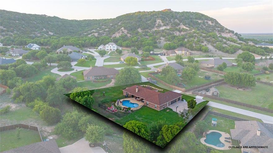 Step into your dream home nestled on almost an acre lot, outside the city limits, where stunning natural beauty meets effortless elegance with an outdoor oasis. This meticulously crafted 4-bedroom, 3-bathroom residence boasts an impressive 2,429 square feet of living space, perfectly tailored to accommodate your most discerning tastes. The spacious open living highlights the stunning stone fireplace filled with an abundance of natural light along with warm neutral colors and wood-like tile flooring. Fall in love with this masterfully designed chef's kitchen complete with knotty alder cabinets, stainless appliances, granite counters, statement lighting and a large walk-in pantry. The adjoined dining area, framed by charming barn doors flows seamlessly to a second living area or flex room offering functionality and elevated entertaining. The primary suite features recessed ceilings, tons of natural light and a true ensuite spa-like bath including a pedestal tub, a walk-in tiled shower, dual vanities and dual walk-in closets. The backyard is a true retreat featuring a sparkling, self-cleaning pool with a slide, an expansive patio with a built-in kitchen area and a custom firepit for pure relaxation and effortless entertaining. This property offers the perfect blend of peaceful country ambiance along with unbeatable West Texas sunsets and panoramic views. Jim Ned CISD.