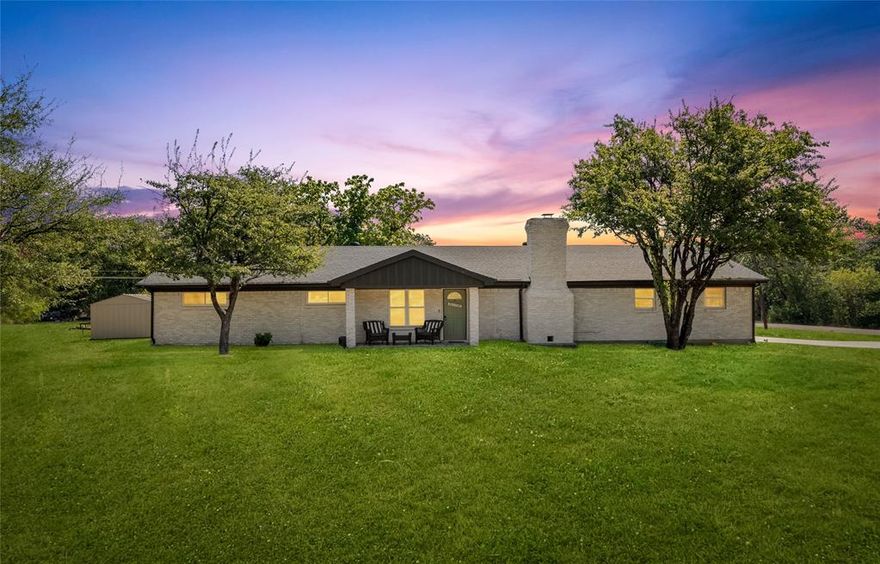 This beautifully updated 4-bedroom, 3-bathroom home sits on a spacious corner lot just outside city limits, offering style, flexibility, and income potential. Professionally remodeled and staged by a top local interior designer, the home is currently a thriving Airbnb and is being offered fully furnished and stocked, with all décor, furniture, and supplies included. Existing bookings through December can transfer to the new owner for instant returns. Inside, you’ll find an open-concept layout filled with natural light, stylish finishes, and thoughtful design. The modern kitchen features quartz countertops, a bold navy island, designer backsplash, and stainless appliances. A large dining area and cozy living room with a fireplace create the perfect gathering space. The four bedrooms are generously sized, and with three full bathrooms, guests or family will enjoy plenty of comfort and privacy. The primary suite offers a spa-like retreat with an updated bathroom. The property offers ample outdoor space with only a portion currently fenced, the lot provides endless options. Add a shop, a guest house, a mother-in-law suite, or even a second rental unit with no city restrictions holding you back. Located in a quiet, picturesque neighborhood near Eagle Mountain Lake, this property perfectly blends convenience with privacy while keeping you close to shopping and dining. Whether you’re looking for your next home, a turnkey short-term rental investment, or a property with room to grow, this one-of-a-kind listing checks every box.