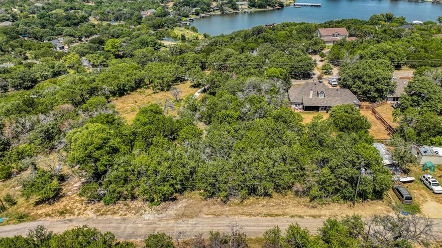 Imagine standing on a gently sloped piece of undeveloped land, where the terrain is full of mature trees and waiting to build your dream home. Being on top of a hill there is a stunning view of Granbury and Chalk Mountain in the distance. You can hear the sounds of peaceful nature and would be the perfect spot for your tranquil retreat.