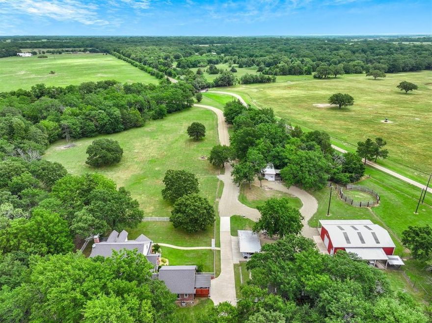Discover the perfect blend of functionality and charm on this 20+ acre property offering a mix of cleared pasture and serene wooded areas. With two ponds, a 30x50 metal barn, 16x12 feed barn, a separate craft barn, corral with loafing shed, large chicken coop and an 8x28 storm shelter, the land is ready for livestock, hobbies, or expansion. The thoughtfully designed home features a spacious wrap-around porch and a quality build with 2in x 6in exterior walls, post tension 18in slab on piers, and a warm, cottage style feel. Inside this lovely home, the primary suite is conveniently located downstairs and includes a sunroom or exercise room for added flexibility. A separate downstairs apartment offers a living area, kitchenette, ensuite bath that is handicap accessible, and a private entrance ideal for multi generational living or guests. Upstairs you'll find another living space, bedroom, full bath, and a stair lift for accessibility. The kitchen has SS appliances, granite counters, island and the butler's pantry make everyday living comfortable and efficient.This peaceful property offers endless potential, including space for additional homes perfect for a family compound or small scale retreat.  Priced under appraisal value!