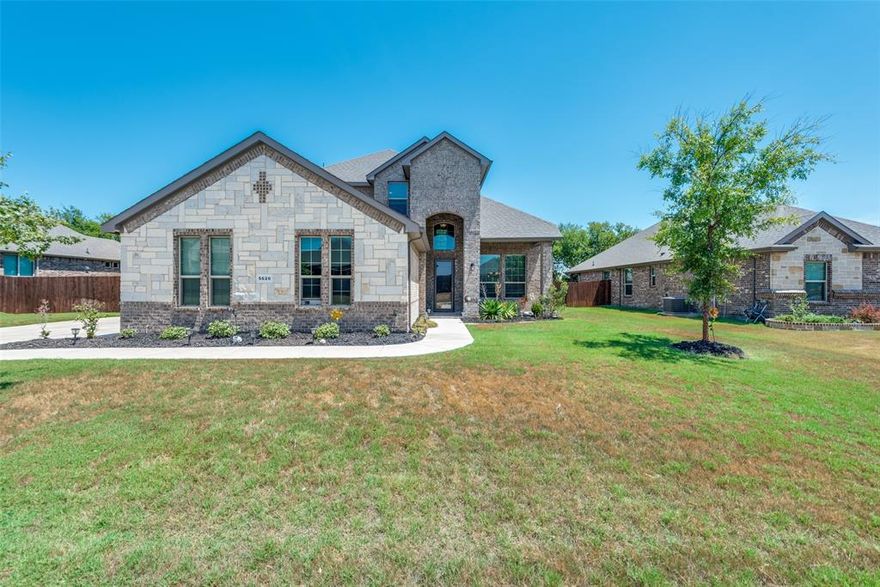 Nestled in the coveted Midlothian ISD, this lovely home sits on approx. 0.39 acres offering a sprawling backyard with a ~100 ft. fence, sprinkler system, and endless possibilities! This exquisite home features a spacious game room, a delightful formal dining, and a dreamy, eat-in kitchen with premium Bosch appliances and breakfast bar.  Reclaimed barn wood paneling adds the perfect character, charm, and warmth to the primary living space. Primary bedroom, stairs, upstairs hallway, and game room have been upgraded with LVP floors. The remainder of the home offers beautiful wood-like tile with comfy carpet in the secondary bedrooms. Home also features a spacious 3 car, side entrance garage with plenty of built in shelves, epoxy flooring, excellent lighting, and even a fan. The stone and brick exterior exudes a timeless appeal while the wide driveway adds a touch of grandeur to the entrance. Home also features both a covered front and back patio. You won't want to miss this beauty!