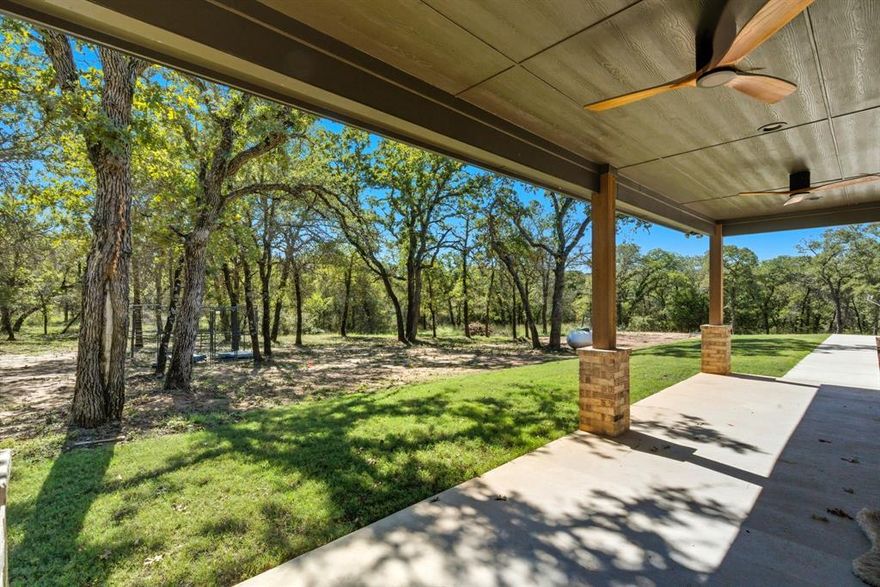 Brand-new and beautifully crafted, this home offers modern comfort, Texas charm, and nearly 3 acres of space in the sought-after Rolling Hills community of Alvord. Designed for both style and everyday ease, the open-concept floor plan showcases soaring 10 ft. ceilings, rich wood-look tile floors, and a welcoming living area with a stone fireplace and custom mantle. The kitchen is a true standout—leathered black granite counters, dramatic quartz backsplash, custom cabinets, butcher block island, gas cooktop, pot filler, and an oversized butler’s pantry built for real cooking and effortless entertaining.

The private primary suite features coffered ceilings, abundant natural light, and a spa-inspired bath with beautiful finishes. Generously sized guest rooms provide comfort for family or visitors, and the split layout creates ideal privacy.

Outside, enjoy peaceful evenings on the covered patio overlooking freshly sodded ground and wide-open views. A prepped pad is already in place for your future 30x40 shop or barn. Wildlife is abundant here, with deer and turkey visiting regularly, and direct access to the LBJ Grasslands offers endless miles of riding, hiking, and outdoor exploration.

This is a rare opportunity to own a brand-new home on acreage in one of Wise County’s most scenic settings—priced well below market for a quick sale.

Come see the lifestyle waiting here.