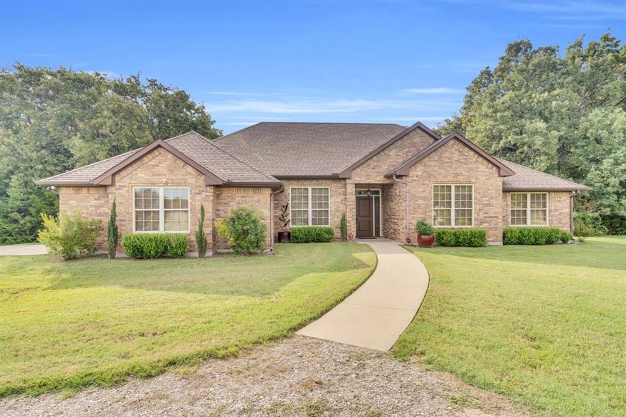 Welcome to your own little piece of the country! A custom built 3 bedroom and 2.5 bathroom brick beauty sits on 5 wooded acres! This home boasts two living areas and two dining areas, so it's ready for all of your entertaining needs. The kitchen has granite counter tops and a bar height eating area for early morning breakfast. The tankless water heater allows for those long hot showers or you can step out onto the porch to soak in the hot tub! While you are out on the porch, look out at the wooded area and you just might see some wild life. Not only does this home have all of these great amenities but its also in a great school district! Come see it today!