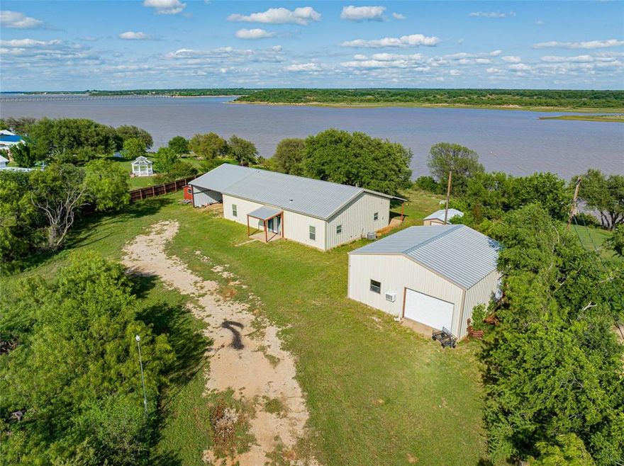 Experience the best of lake life with this spacious move in ready 3 bedroom, 2 bath waterfront home offering 1,944 sq ft on 3 scenic acres along the shores of Hubbard Creek Lake. Known for its excellent fishing, boating and peaceful surroundings, this property is perfectly positioned to enjoy everything the lake has to offer. The home features an open concept layout with generous living and dining areas, along with a spacious primary bedroom with a generous size walk in closet. Two extra bedrooms are located on the opposite side of the home with a bathroom in between them. A key highlight of the home is a covered back porch that faces the east and captures the serene lake views perfect to sit an enjoy nature and the perfect place to relax. Outside you will find a 900 sq ft detached garage and or shop ideal for valuable storage or workspace that has a concrete pad with electricity perfect for parking that boat or all other storage needs. The expansive lot of 3 acres provides privacy while maximizing those incredible waterfront views and still offering easy access to the lake for fishing, boating, and enjoying everything Hubbard Creek Lake has to offer. Only a few minute drive to the town for any supplies one may need.  Whether you're looking for a lake retreat or a homestead with room to grow, this property delivers space, privacy and relaxing views. Call for your private showing!