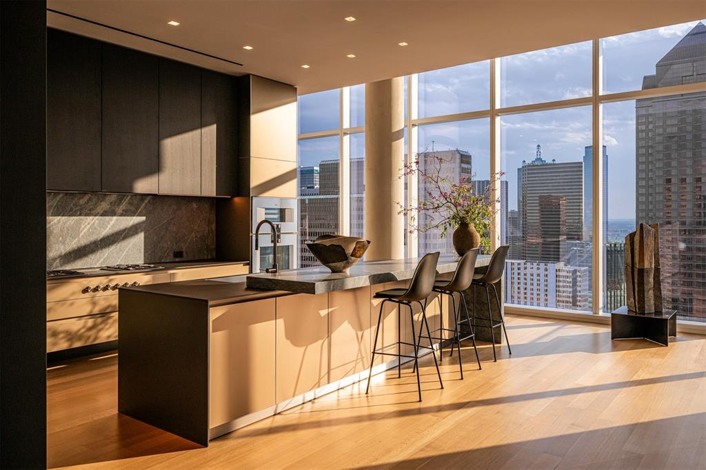 The Gallery Penthouse at HALL Art Residences in the Dallas Arts District is a full-floor custom home on the 26th floor. Direct elevator access into this 4 Bedroom, 4 Bath, 2 Powder Bath home with 7,688 sq ft offers floor-to-ceiling windows, 12-foot pocket doors and hand-troweled plaster columns throughout. The Living Room showcases 14-ft ceilings, a monumental fireplace and wine cellar. The Gourmet Kitchen is designed with bulthaup cabinetry, Gaggeneau appliances and an oversized customizable butler pantry. Enjoy unobstructed panoramic views of the Dallas skyline in the dining room and private terrace. The Primary Bedroom suite is a serene retreat complete with its own private terrace. The spa-inspired en-suite Bath offers two spacious walk-in closets, soaking tub, large shower, heated floors, and a smart mirror. Other distinctive features are a private Library with a fireplace, 2 Utility Rooms and raised flooring system. This home was designed by the renowned design team at Abeyta Architecture Studio, Dallas. Furnishings and art curated by Neal Thomas Enterprises, New York City.