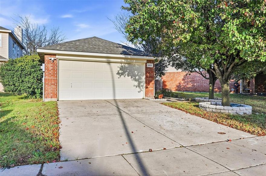 This 3 bedroom, 2 bath home offers 1408 square feet of comfortable living space on a quiet cul-de-sac with a treed lot and a large fenced backyard. Inside, wood floors run throughout the home and the neutral colors create a clean, move in ready feel. The layout is open and welcoming, with a large living area that connects easily to the eat in kitchen. The kitchen features a breakfast bar, plenty of cabinet space and a clear view into the family room. The primary bedroom has generous natural light and sits separate from the secondary rooms for added privacy. The bath includes a garden tub and a walk in closet. A standout feature is the oversized utility and pantry combination room off the dining area, offering extra storage and room for a freezer. The home also includes a two car garage with a single door, wifi enabled opener and an exterior keypad for convenient entry. Practical features such as a gas water heater, security system, sprinkler system add everyday ease. Outside, the cul-de-sac setting, mature trees and wide backyard create a relaxed space for outdoor time. The location adds even more appeal with quick access to Alliance Town Center, and an easy drive to Southlake, Grapevine and the north entrance of DFW Airport. The home is part of Keller ISD and the HOA offers three pools, hike and bike trails and sports courts.