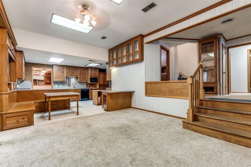 This distinctive two-tier floor plan blends character and functionality, offering a versatile home and work lifestyle. The formal living and dining spaces flow seamlessly into a step-down level featuring a second living and dining area, anchored by an open kitchen with custom cabinetry and built-in breakfast area ideal for both everyday living and entertaining. Provides three spacious bedrooms, three full baths, and two half baths, along with a thoughtfully designed attic conversion that creates a private bonus room retreat for work, relaxation. For those who value space and utility, the property truly shines, two separate front-entry garages complement an additional extraordinary 1,200+ sq. ft. heated and air-conditioned workshop or studio, complete with its own bay door alley entrance or making it a 3rd garage can fit 4 additional vehicles.