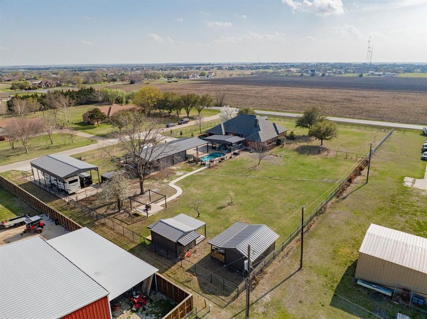 Welcome to the property that spares no detail for opportunity and serenity. You will find the best of both worlds whether working in your 30x30 workshop, getting your RV recharged for you next outting, or relaxing by the heated, salt water pool. Both sheds on property will stay, along with the 50 Amp and 500 Gallon propane tank. Indoor, the owner’s have created an open kitchen concept with a family sized walk-in pantry, with both a breakfast nook and formal dining. The primary boasts a his and hers walk-in, each with vanities, and a built-in shoe rack to compliment.