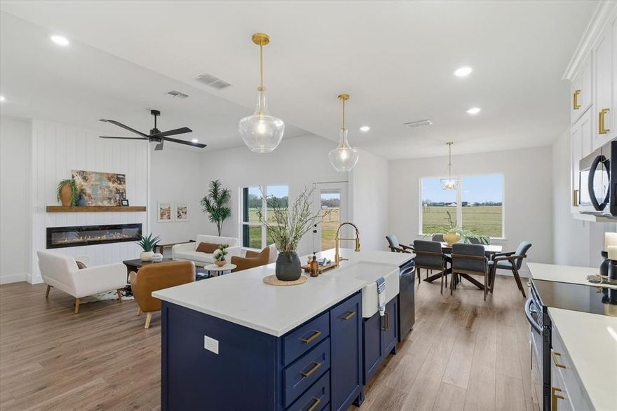 Beautiful 2025 Douglas Home situated on 1 acre with enhanced curb appeal including newly added exterior shutters. This 4-bedroom, 2-bath home offers approximately 2,205 square feet of open-concept living with abundant natural light throughout. The spacious living area features a 6-foot electric fireplace and large windows that provide excellent natural lighting. The kitchen includes a large island with farmhouse-style sink, white herringbone backsplash, stainless range, dishwasher, and refrigerator. A generously sized pantry offers substantial storage space.
The home also includes an oversized utility and laundry room with additional storage and space for an extra refrigerator or freezer. Foam insulation provides energy efficiency, and CAT5 wiring is installed throughout the home, including the back porch, along with a dedicated media closet. The primary suite includes a spacious bedroom, dual-sink vanity, walk-in closet, and separate bath area. Secondary bedrooms offer flexible space for guests, office, or additional living needs. Sellers concession available with an Acceptable Offer! Let’s get you scheduled for a private tour!