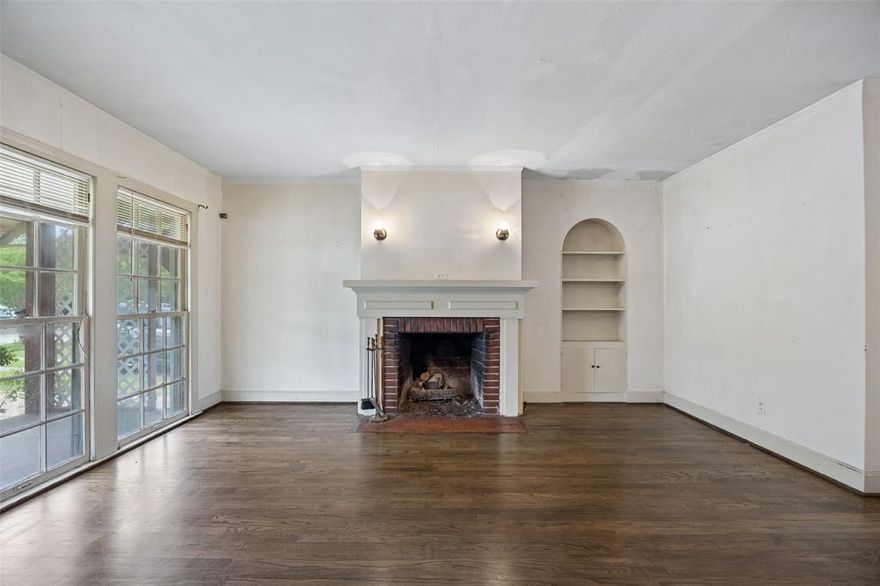 Nestled in the sought after Ravinia Heights neighborhood, this charming two bedroom, one bathroom cottage overflows with character and potential. You are a short walk from Moss Park and minutes from Wynnewood Village, featuring the new Target and LA Fitness. Step inside the welcoming main living room with a large gas fireplace and vintage custom built-ins. The adorable dining room is full of historic charm with lovely corner built ins. A fantastic highlight is the spacious second living area, bathed in natural light from walls of windows that perfectly frame views of the backyard. The roomy kitchen serves as a great blank slate, ready for your fresh design ideas. While the home requires a full update, the enchanting architectural details provide an amazing foundation to create your dream space. Please note this is an estate property being sold strictly as is. This is a rare opportunity to bring your vision to life in a truly fantastic community!