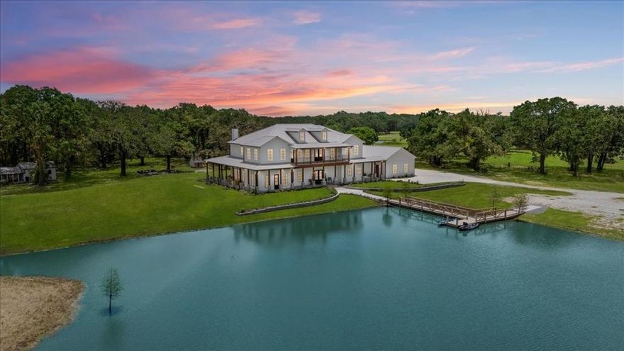 Just 35 miles from Dallas, Trinity Hills Ranch is a luxurious 38-acre estate offering the perfect blend of serene country living and modern convenience. This stunning property features a 6,000 sq ft custom-built residence with a 3-car garage, 3 stocked ponds, 4 cattle ponds, and lush pastures ideal for livestock grazing. The wrap-around porch and second-floor balcony showcase breathtaking views of rolling hills, sunsets, and peaceful nature, making this home a true retreat.
Inside, the spacious open floor plan is designed for entertaining, with a chef’s kitchen boasting oversized double islands, high-end appliances, and a generous dining hearth. The secluded primary suite is a private oasis with large windows that flood the room with morning light. An additional downstairs bedroom and office offer tranquil pond views. Upstairs, you’ll find 4 bedrooms, 2 full baths, a loft, and a bonus room with a balcony, perfect for a gym, media room, or secondary office.
For outdoor living, enjoy a custom-built outdoor kitchen, fire pits, a chicken coop, and a charming playhouse. This property is perfect for those seeking a luxurious ranch lifestyle without sacrificing proximity to dining, shopping, and entertainment just outside the Dallas city limits.