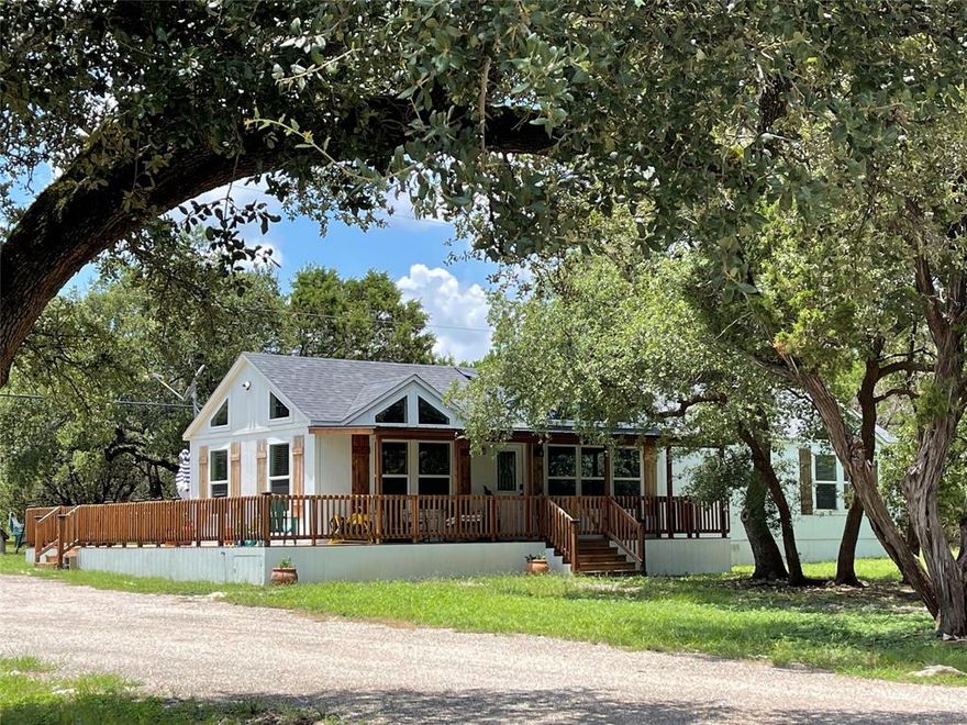 Charming 2 bed 1 bath home built in 2021, on .69 acres in The Canyons on Lake Whitney.  Open concept, with granite counter tops, ship lap, lots of windows, tall ceilings makes it seem much larger than the 1080 sq ft. Loft is 270 sq ft, total 1350 sq ft.  The kitchen is amazing.  Beautiful lighting throughout.   The covered front deck wraps around the house to an open deck.   Very nice wooden railing.   This home has three mini splits, spray foam insulation in walls, ceiling and floors, waterproof vinyl plank flooring.  Aerobic septic, 8x10 storage bldg, and this home comes with total lots with the property going from road to road.  Plenty of room to park your RV, boat and any lake toys.   Also, room to build a workshop, and garage.   Lot's of wildlife throughout the area.   Short distance to the community boat dock and boat ramp.   This area has a Community Center with various events including a Dinner each month for property owners.