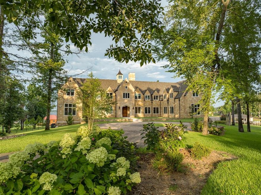 Waterfront masterpiece on Lake Palestine with 438’ shoreline! English Cotswold Manor house design, lovingly researched & painstakingly built. Stone entrance, aged concrete drive, cobblestone circular drive. The circa 1800's front door leads to grand entry hall, formal dining, great room (quarter sawn oak paneling, hidden storage behind oak panels, stone fireplace, European oak flooring & posts & beams), & pantry with sub-zero refrigerator. Gourmet kitchen with Wood Mode cabinetry, Sub-Zero fridge & freezer, Wolf range & microwave, Scotsman ice maker & stone tile walls., Home gym, billiards room, safe room with steel door, marble flooring, & en-suite baths throughout. Upstairs Upstairs are 6 add'l bedroom suites - 2 over-sized to accommodate larger families + bonus or media room. Outdoor fireplace & kitchen, terrace, & boathouse with 3 electric lifts. Solar water heater, generator, foam insulation, hospital grade water filtration. Amenities are endless!