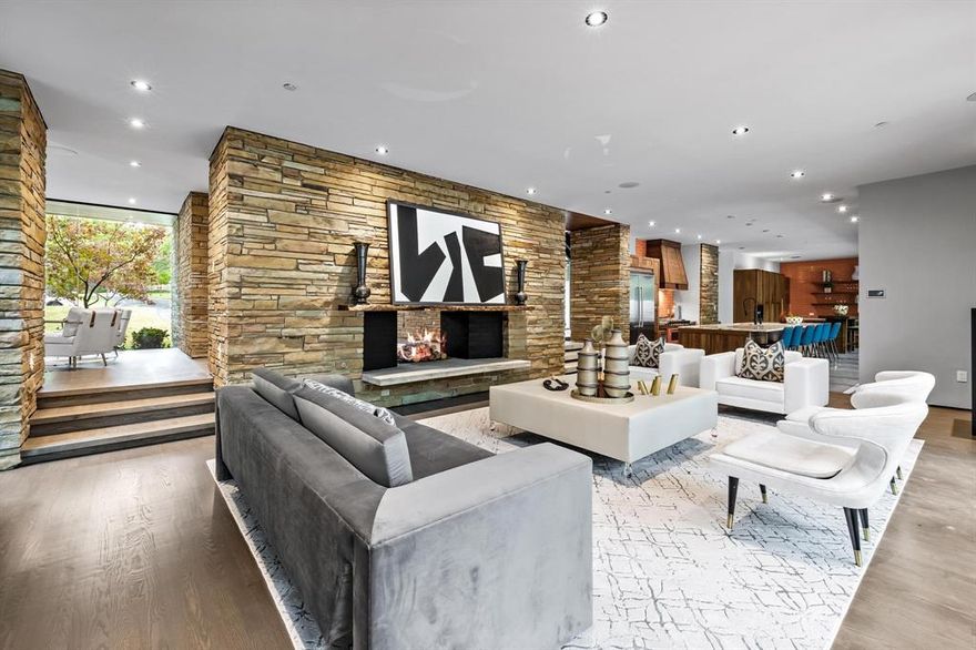 One of a kind Cliff Welch designed home built in 2000 in Chapel Hill Estates was featured in Texas Architect Magazine in July 2004! The house sits on a site that backs up to a small creek lined with mature trees and a short walk to White Rock Lake. Horizontally laid Tennessee Crab Orchard ledge stone serves as a strong design element throughout the house and is uniquely blended with cream colored brick, drywall and glass. The same stone is used as the spine of the house dividing the first floor level at the rear of the house which steps down to the redesigned kitchen and spacious living area. Floor to ceiling windows at the front entry, dining and lounge area look into the freshly landscaped front yard and a NanaWall folding glass system overlooking the covered back patio, pool and separate steam room. The kitchen has been redesigned which includes a Viking Refrigerator, Bertazonni Arancio Professional 48” Gas Range, Miele Dishwasher and built in Coffee Maker.