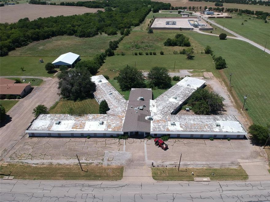 WOW...under $22 per SF, value is in the 3 acres or remodel the 25,000sf building located in North Cleburne.  Zoned Commercial, previously used as a nursing home.  Located close to where the new growth is happening in Cleburne.  Use your imagination...Lots of potential to be remodel and repurpose the building or the land.  Needs a lot of work but for the low asking price and rehab costs, you should be under $100 per sf after all remodeling is complete and the building is beautifully remodeled. It was a former nursing home, large common areas, offices, a kitchen, and 60 rooms, exterior was recently painted light gray.  Each room is equipped with half bath and closet.  Zoned C3 (commercial) can be office or retail, assisted living, office suites, warehouses, self-storage, or a school.  Room to build more behind it on approx 1 acre in back. Close to ballpark...The Depot, and Hwy 67, and Chisholm Trail.  Great location! Go during daylight, no electric. Lots of SF to convert and room to expand...bring your ideas and contractors!