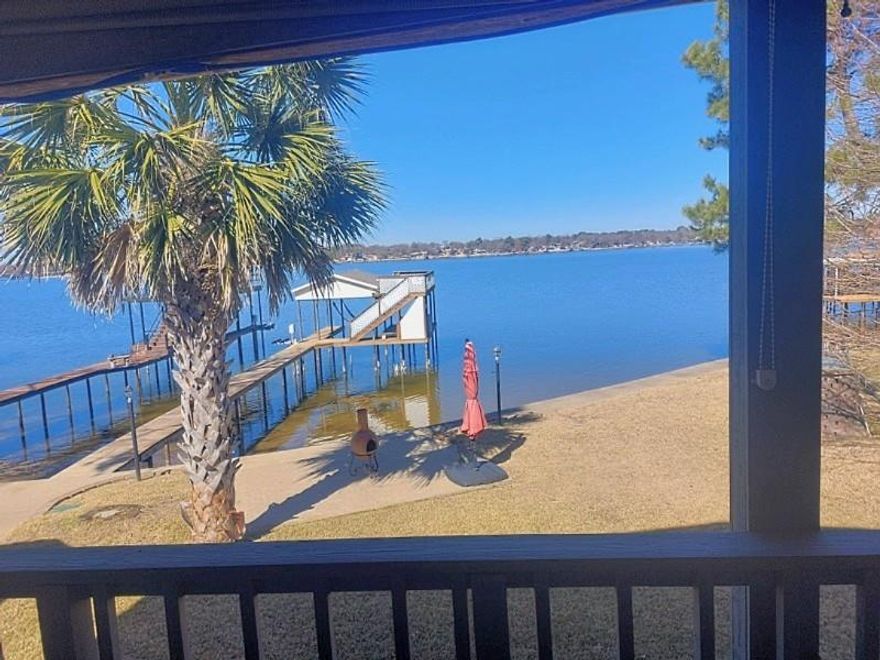 IF YOU'VE ALWAYS WANTED THAT MILLION $ WATERFRONT VIEW WITHOUT THE PRICETAG, THIS IS THE HOUSE FOR YOU!  This well-maintained home has it all! With 3 oversized bedrooms everyone will have room to enjoy.  Each bedroom also has its own bathroom plus an additional half bath for guests to use!  Relax by the fire in the spacious living room while you enjoy the views of the lake! Or head outside and enjoy them from the 30' deck!  The home boasts multiple places for fun, relaxation, and of course fishing!  There is deep water at the end of the boat dock so you can enjoy your time on your boat longer when the lake is low!  There is ample storage throughout the house, multiple closets and even a basement and a tool shed!  Feel like exercising? Head out to the exercise room as the workout equipment stays!  The well-appointed kitchen features granite counters, custom cabinetry, and even a wine rack!  There is ample parking so there's room for everyone!  The roof is approximately 4 years old and both HVAC units are less than 5 years old.  The home is move in ready, make it yours so you can start living the 'lake life' and enjoy all the many features this home has to offer!