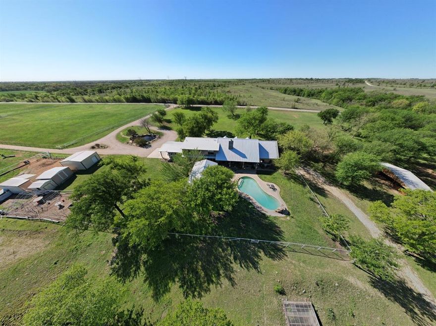 Experience the perfect blend of country charm and modern function with this impressive working horse ranch set on over 30 acres in the heart of North Texas. This turnkey property offers a rare opportunity to own a fully operational equestrian facility with a long-standing reputation and outstanding infrastructure. 

The main residence spans over 4,200 sf and features 6 spacious bedrooms and 4 bathrooms, pool, outdoor living and kitchen providing a comfortable retreat. In addition to the main home, there is a lodge with 4 bedrooms and 2 bathrooms (1,280 sf), a charming cottage (16x16), and multiple apartments—all ideal for staff, extended family, or guest accommodations.  The 2 story apartment is 25x16 on the first floor and 16x16 on the second floor. An additional arena apartment overlooks the arena, is 840 sf and has an elevator. The 1 bedroom RV with 2 slide outs measures 30x8. With a total of 16 bedrooms and 15 bathrooms across the property, space and flexibility are abundant.

Designed to suit a variety of equestrian disciplines, the ranch includes 45 horse stalls across several well-maintained barns, a 150 by 250-foot arena perfect for training and events, and 13 individual paddocks. The facility also features a quarantine barn, 4 tack rooms, 10 separate pastures with individual water sources, and 3 run-in sheds. For larger events, an inviting outdoor cantina and dance pavilion provide ideal spaces for hosting celebrations, clinics, and community functions. 

Added conveniences include a full industrial kitchen to serve large gatherings, 12 recreational vehicle hookup sites with 2 dump stations, extensive hay storage, multiple workshops, and livestock feeders. The property boasts a recent $1 million investment in new roofing across multiple buildings, enhancing its quality and longevity.

Whether you're expanding an established equestrian operation or seeking a multifunctional family ranch, this expansive estate is ready to fulfill your vision.