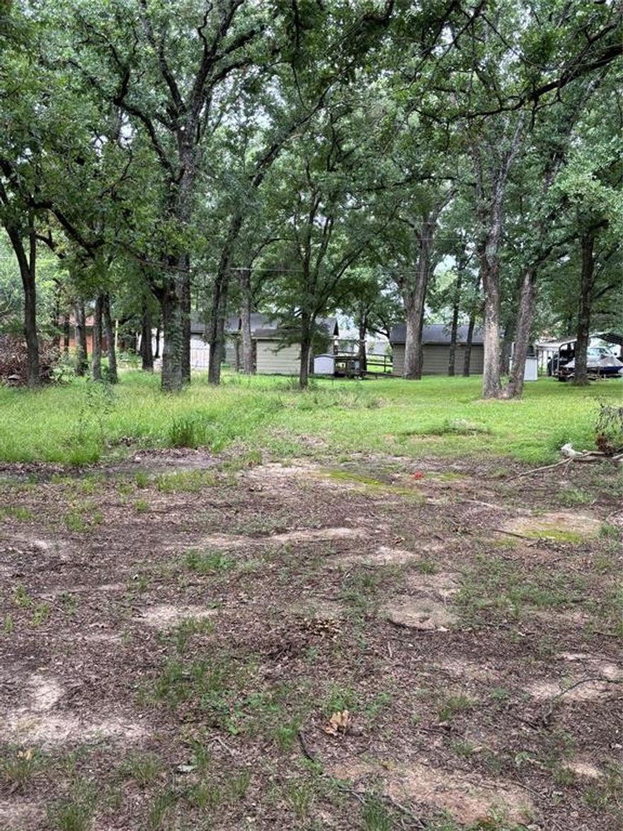 Cedar Creek Lake Lot For Sale – Build Your Lake Retreat Getaway in Gun Barrel City, TX! 
Looking for lake lots for sale in Texas where you can enjoy peaceful surroundings, easy access to the water, and a true lake lifestyle? This ¼-acre treed lot in the quiet Mantle Manors subdivision at Cedar Creek Lake (Cedar Creek Reservoir) checks all the boxes.

Located just one block from Cedar Creek Lake, this property offers a tiny lake view, and is only steps from the neighborhood boat ramp and park, making it ideal for those who love fishing, boating, swimming, kayaking, and other water sports.

* Public water & sewer available in the neighborhood (buyer to verify connection process and costs)
* A quiet and established lakeside community with tall trees and nature all around
* Gun Barrel City location – close to shopping, dining, and entertainment while still feeling tucked away
* No timeline to build – perfect for a weekend retreat, retirement home, or investment property
* Neighborhood does not allow mobile or manufactured homes. Site-built homes only.
* Just 1 hour from Dallas and 1.5 hours from Fort Worth – an easy weekend escape!

Cedar Creek Lake is one of the most popular fishing destinations in Texas, known for bass, catfish, and crappie. Whether you want to cast a line, spend your days on the boat, or just relax and enjoy the lakefront lifestyle, this property is a rare opportunity.

Mantle Manors – Cedar Creek Lake – Gun Barrel City, TX