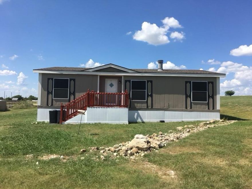 Enjoy country living on a full acre with room to spread out and breathe, while enjoying a panoramic view of the distant neighborhoods. This well-kept 3bedroom, 1 bath home offers a cozy living area with a fireplace-perfect for Texas winter nights. Bring your horses, chickens, RV and boat-there's plenty of space and the property already includes a chicken coop. No HOA limits and wide space to park equipment, toys, or additional vehicles. The roof was replaced just over a year ago. If you've been looking for your own homestead where you can enjoy animals, sitting around a rock fire pit in the backyard, privacy, and the freedom of country life-this is it.