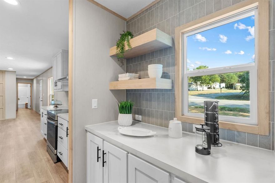 Homebuyers searching for the perfect floor plan and features will love the Clayton – Mariner. This 3-bedroom, 2-bath home is designed with comfort and convenience in mind. The private primary suite features a spa-like bath with dual sinks and an easy-access 5 ft shower, while the laundry room and built-in coffee bar are thoughtfully located just down the hall. The open concept living area is perfect for entertaining, highlighted by a 7 ft kitchen island with seating for 4, stainless steel appliances including refrigerator, deep sink, and range hood. The large living room offers flexible space with easy access to secondary bedrooms and a second full bath. Energy efficiency is built in with Energy Star appliances, a smart furnace, and a programmable thermostat to help control monthly utility costs. Outside, enjoy a fully fenced backyard and 8x20 back deck, ideal for relaxing mornings or evenings. Located in the waterfront community of Indian Harbor, just minutes from historic Granbury, this neighborhood features a gated entrance, pool, parks, boat ramp, marina, and café—making it the perfect place to call home.  Home qualifies for USDA financing due to location with ZERO down.