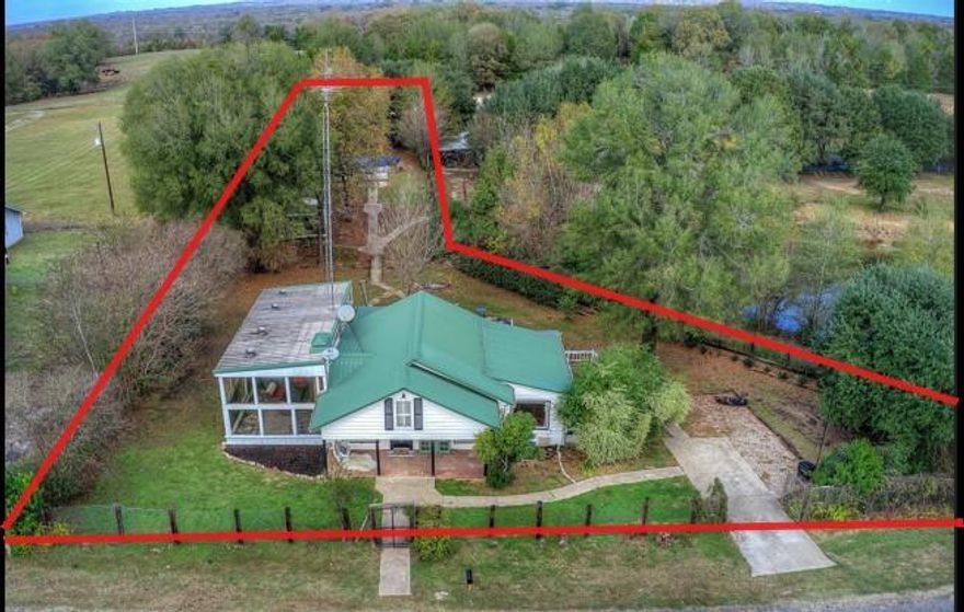 Discover a charming East Texas property anchored by a 122-year-old farmhouse with documented history and long-standing character. Originally built as a private homestead, the main farmhouse offers two bedrooms and one bath, 
blending historic appeal with updated functionality. 
The property also includes one guest cabin (casita) with its own bath, making it ideal for guests, extended family, or separate living space. An above-ground pool with decking and pool cover is perfect for weekend get-togethers and cooling off during hot East Texas summers.

The setting offers space and privacy while remaining manageable for everyday use—well suited for a full-time residence, weekend property, or small multi-dwelling setup. With its historic farmhouse, additional living space, and outdoor amenities, this property offers flexibility.
A unique opportunity to own a piece of East Texas history that’s practical, livable, and ready for its next chapter.