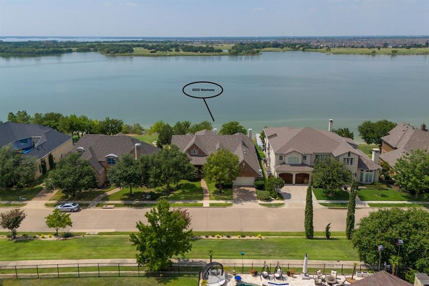 1.5 story lakefront home in Stewart Peninsula, near 121, The DNT, & Marina. Boating enthusiasts will love the 3 car tandem garage perfect for keeping your boat at home & putting in at the ramp just minutes away. The floorplan of this approx. 4,172 SF lake home can't be beat. All bedrooms are located on the main floor, have ensuite baths & spacious walk-in closets & are separated from one another. Family room, Living room, kitchen & master all enjoy big, open water views. The office was originally a 4th bedroom in the building plans, has a closet, and could be a 4th bedroom if needed. Gameroom with balcony & gorgeous lake views upstairs. Be sure to check out the floorplan in the photos! The two tier backyard features a covered stamped concrete patio with gas hookup for a grill, built in speakers, and a stairway to get down to approximately 85' of lake frontage. The master bedroom has a large sitting area, tray ceilings, double entry closet, gorgeous lake views, & door to the patio. Spacious master bathroom with spa tub & huge double entry walk-in shower. Excellent storage throughout the house, built in cabinets practically everywhere. The kitchen overlooks the living area & comes with a double oven, electric cooktop, island, lots of counterspace & more stunning views!  Triple crown molding, multiple dining areas, three large living areas, 2 fireplaces, covered balcony, 3 car garage and much more! Location can't be beat! Imagine watching the sunset while enjoying the negative edge pool & the lake beyond at the adult only community pool just down the street. The family pool isn't far, either. Want your own pool? There is room. And all of the shopping, dining & recreational opportunities of the 121 corridor are only minutes away, making this your dream lake house in the dream location. Sellers have recently repainted & had carpet replaced. Boat & ride mower stay with full price contract!