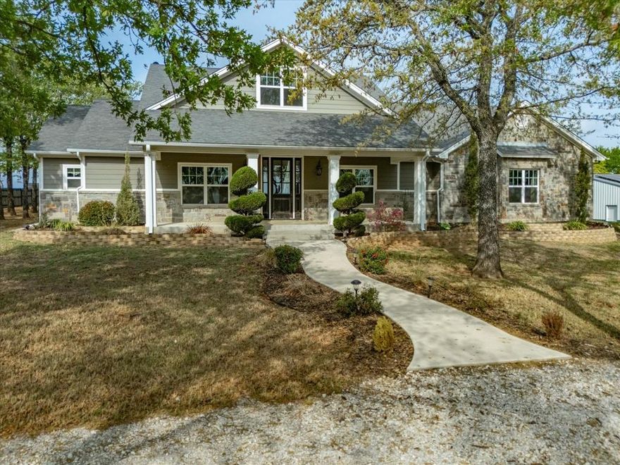 Experience peaceful country living on this beautiful 3-acre property located just outside of city limits with a short and convenient drive to Highway 287 for commute. This stunning home offers engineered hardwood flooring and soaring 20-foot ceilings that create a grand, open feel throughout the main living space. The living room features custom built-in cabinets, adding both style and functionality.  The kitchen is equipped with granite countertops and ample space for cooking and gathering. Upstairs, a versatile bonus room overlooks scenic Amon G. Carter Lake, offering the perfect space for a game room, office, or additional living area.  All windows on the back of the property enjoy Amon G Carter view!  Enjoy the benefits of energy efficiency with installed solar panels that cover most months’ electricity usage. Outdoors, you’ll find a 30x40 insulated shop complete with electricity and two overhead doors—ideal for hobbies, storage, or workspace needs and garden space fenced as well.  With plenty of room to relax, entertain, and take in the lake views from the back of the property, this home offers the perfect blend of comfort, functionality, and country charm.