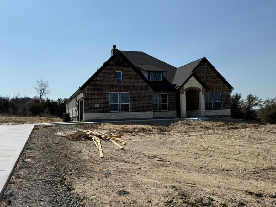 Estimated March 2026 completion! Ask us about our Trade In Trade Up program, we can buy your home! The Verbena floor plan features a modern, open-concept layout and the sought-after features today’s homeowners are searching for. With four bedrooms, three bathrooms, and a flex room, this plan boasts just over 2,400 square feet of functional living space. Upon entering the home off the front porch, you’re welcomed by an inviting foyer. Immediately to the left is a hallway with a bedroom, walk-in closet and full bathroom, as well as a linen closet. Across the foyer is a flex room, perfect for a home office, formal dining room or whatever need your family has for the space. Past the foyer is the family entry, with storage space and mud bench, which leads to the laundry room and two or three car attached garage. Through the entrance, the home opens up to a large family room with a stately fireplace. Adjacent to the family room is a gourmet kitchen, equipped with a walk-in pantry, ample counter space and an oversized island. Finishing off this open-concept living area is a dining space which overlooks the covered back patio. The remainder of this one-story floor plan is just off the living space. A hall leads to two bedrooms with walk-in closets, another linen closet and a shared full bathroom. The back corner of the home offers privacy for the owner’s suite, featuring a massive walk-in closet and bathroom with a dual-sink vanity, standalone soaking tub and glass-enclosed shower.