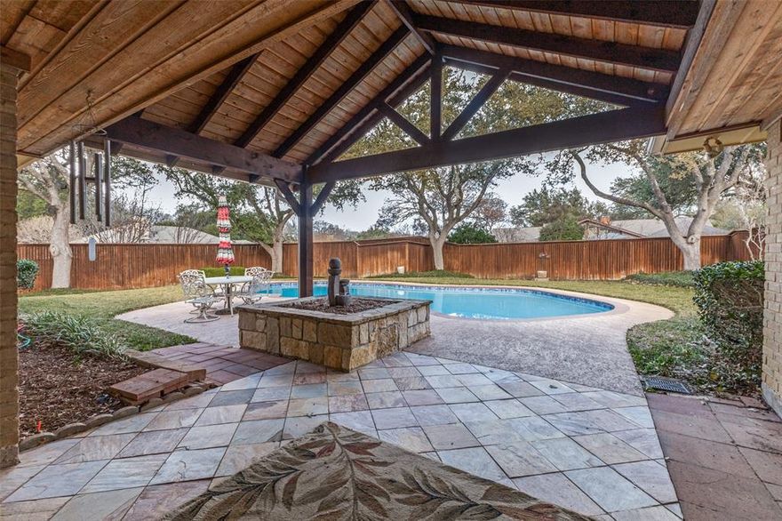 This charming single story 4-bedroom home beautifully embodies a mid-century modern inspired design. The architecture showcases clean lines and an open, welcoming layout reflects timeless elegance. The outdoor private pool and covered patio add the final touch! Incredible beautiful mature trees boost the overall charm of this property! One of the standout features of this home is the gorgeous floor-to-ceiling windows filling the interior spaces with abundant natural light. This feature contributes to the home's open and airy feel. The thoughtful layout throughout makes this space ideal for both relaxing and entertaining guests. Vaulted ceilings in the living and primary bedroom accentuate the gorgeous brick walls and fireplaces. Spacious kitchen with granite counter, double oven, gas cooktop and plenty of cabinet storage will delight any chef! Enjoy the fantastic views of the outdoor space and sparkling pool from many rooms within your home. Massive covered patio in rear, over 325 square feet, is the perfect place to relax and get some shade between swimming sessions.  Interior newly painted, vinyl plank flooring recently added. Circular drive, oversized garage, plus a 30x20 pad at rear alley for extra parking.  Complete HVAC system replaced within past 2 years, which helps to avoid a huge expense. This beautifully designed home offers a blend of style, comfort, functionality, elegant features, and practical updates making it the perfect space to enjoy life for years to come.
