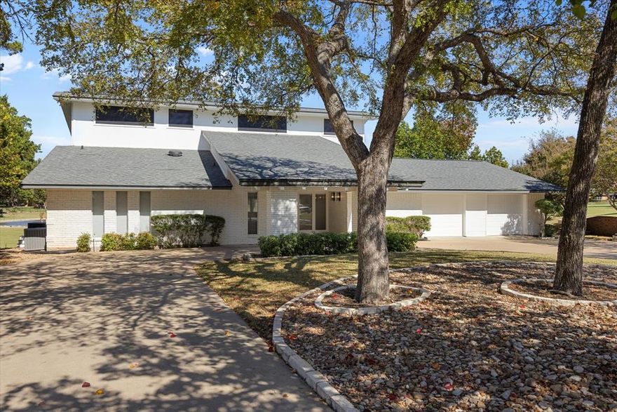 Located on the 17th green of the beautiful Pecan Plantation golf course, this stunning contemporary mid century modern home is ready for your next adventure. Freshly painted throughout with tons of recent updates like quartz counters, trendy new backsplash, ceilings fans, fixtures and more make this 3 bedroom, 3 bath and 2 living room home THE ONE!. No parking issues here! Located on a cul de sac street, this home has a huge circle drive to fit several cars as well as a port-cochere. Garage features 2 car parking, golf cart space with its own access and a small shop area inside. Take in the water feature and golf course views from the outside deck or from the open concept main level living WALL of WINDOWS with no privacy issues thanks to the custom REMOTE CONTROL BLINDS! The master ensuite is located on the 1st floor with WB fireplace, golf and water views and literally a ROOM SIZED walk in closet. Upstairs you will find an Extra family room with plantation shutters, 2 bedrooms, balcony and full bath. Hidden HUGE storage access in second bedroom closet-be sure to check it out. Large main floor laundry room just off the garage even has a shower. Super close to the Country Club and other Pecan amenities including Grocery, Fitness Club, Swimming Pools, Restaurant, Pharmacy, Bank, Medical, Beach, Stables, Walking trails and more! 2 gated & guarded entrances. Come make new friends in a community with tons of activities for all. Enjoy your destination life in Pecan Plantation!