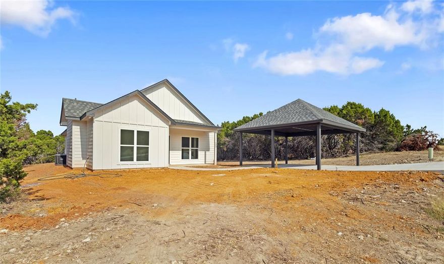 Welcome to this 3 bedroom, 2 bath New Construction situated on a spacious half-acre lot just minutes from Lake Whitney. This property features an open-concept floor plan with raised ceilings throughout. Vinyl plank flooring in the main areas and cozy carpet in the bedrooms. The kitchen offers a large island, quartz countertops, and abundant cabinetry, providing both style and functionality.The primary suite includes a walk-in closet and an ensuite bath with a duel vanity and quartz countertops. Additional highlights is a generous laundry room with ample storage space and a 2-car carport. Enjoy comfortable living and plenty of outdoor space, conveniently located near marinas, recreation areas, and all that Lake Whitney has to offer. Sod will placed before closing and Builder is offering concessions!